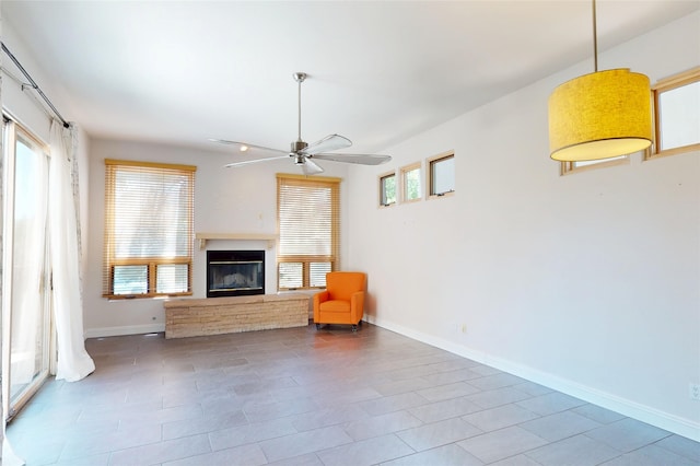 5045 Carriage House Dr, Los Alamos, NM 87544 - unfurnished living room featuring ceiling fan, a glass covered fireplace, and tile patterned flooring