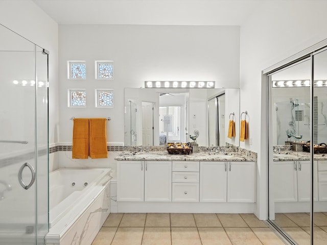 16 Coyote Pass Rd, Santa Fe, NM 87508 - bathroom featuring tile patterned floors, double vanity, a tub with jets, and a shower stall