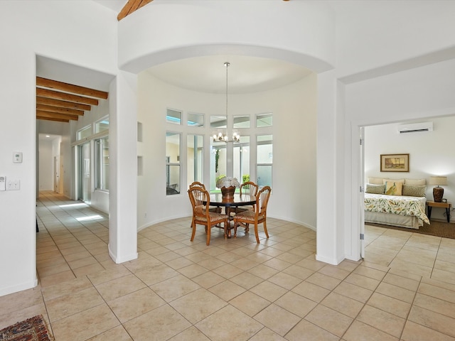16 Coyote Pass Rd, Santa Fe, NM 87508 - dining area featuring a chandelier, light tile patterned floors, a wall mounted air conditioner, a towering ceiling, and beam ceiling