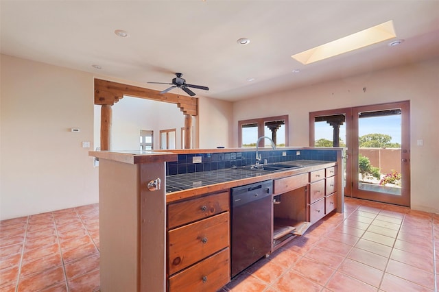 35 Avenida De La Paz, Lamy, NM 87540 - kitchen featuring dishwasher, tile countertops, a skylight, recessed lighting, and light tile patterned flooring