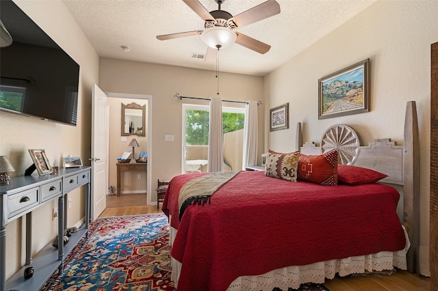 4351 San Benito Unit A, Santa Fe, NM 87507 - bedroom featuring wood finished floors, ceiling fan, access to exterior, and a textured ceiling