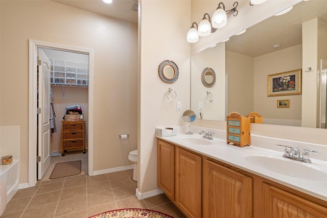 4351 San Benito Unit A, Santa Fe, NM 87507 - bathroom with double vanity, tile patterned floors, a tub, and a walk in closet
