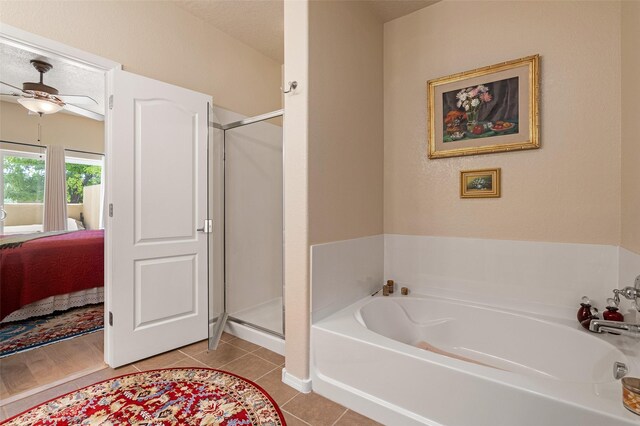 4351 San Benito Unit A, Santa Fe, NM 87507 - bathroom with connected bathroom, a garden tub, a shower stall, a ceiling fan, and tile patterned floors