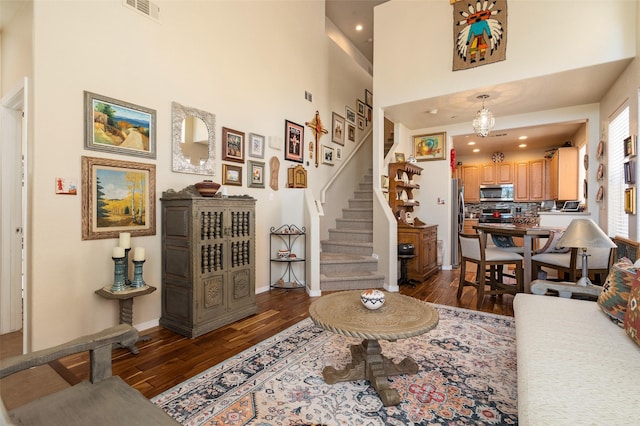 4351 San Benito Unit A, Santa Fe, NM 87507 - living room featuring dark wood-style flooring, stairs, a towering ceiling, and recessed lighting