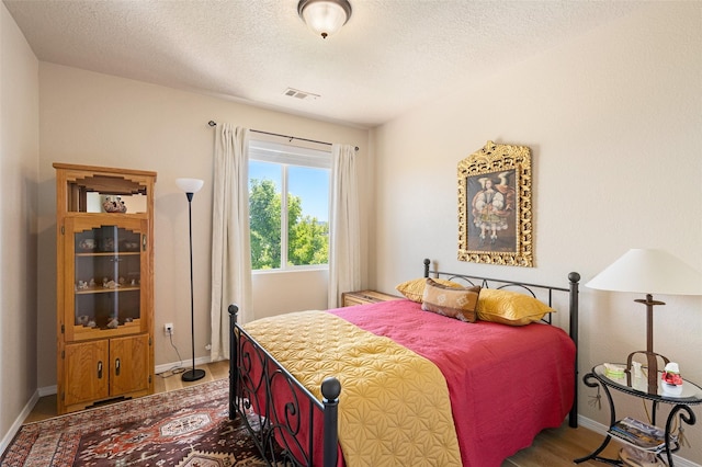 4351 San Benito Unit A, Santa Fe, NM 87507 - bedroom featuring wood finished floors and a textured ceiling