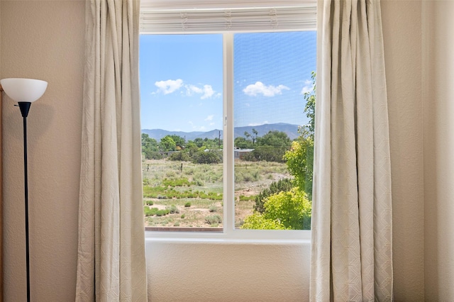 4351 San Benito Unit A, Santa Fe, NM 87507 - doorway to outside with a mountain view, plenty of natural light, and a textured wall
