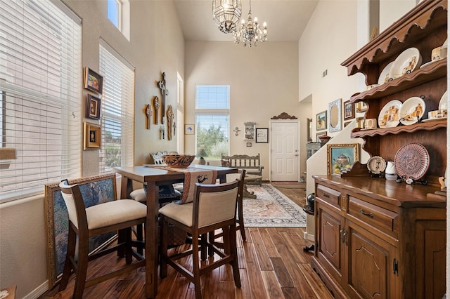 4351 San Benito Unit A, Santa Fe, NM 87507 - dining area with a high ceiling, plenty of natural light, a chandelier, and dark wood-style floors