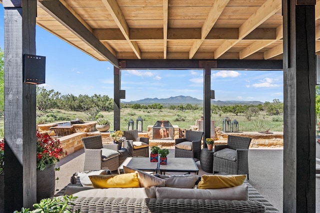 24 Whispering Spirits Dr, Cerrillos, NM 87010 - view of patio / terrace with an outdoor living space with a fire pit and a mountain view