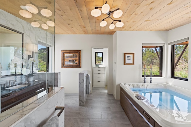 24 Whispering Spirits Dr, Cerrillos, NM 87010 - bathroom featuring wooden ceiling, a chandelier, a garden tub, and vanity