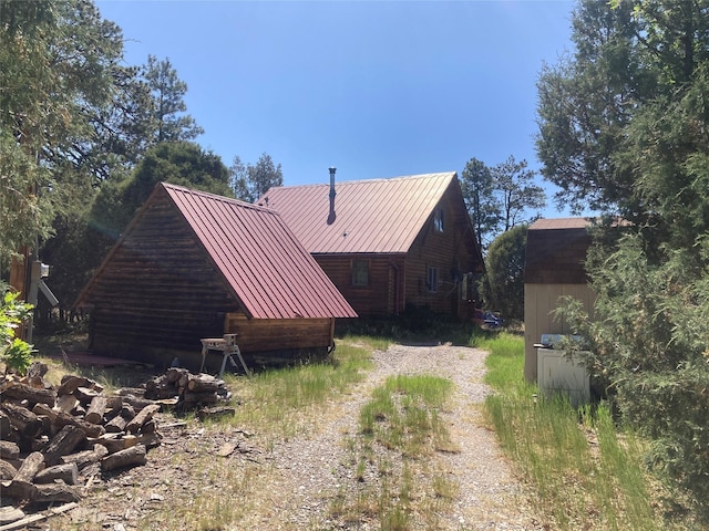 32 Doe Rim Loop, Los Ojos, NM 87551 - view of home's exterior with an outbuilding and a metal roof