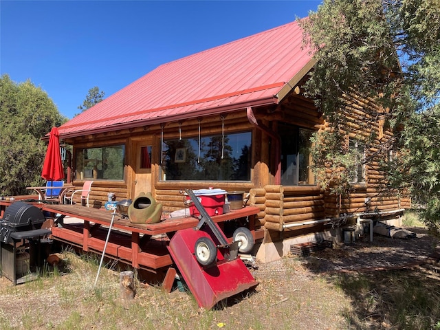 32 Doe Rim Loop, Los Ojos, NM 87551 - rear view of property with log exterior and a metal roof