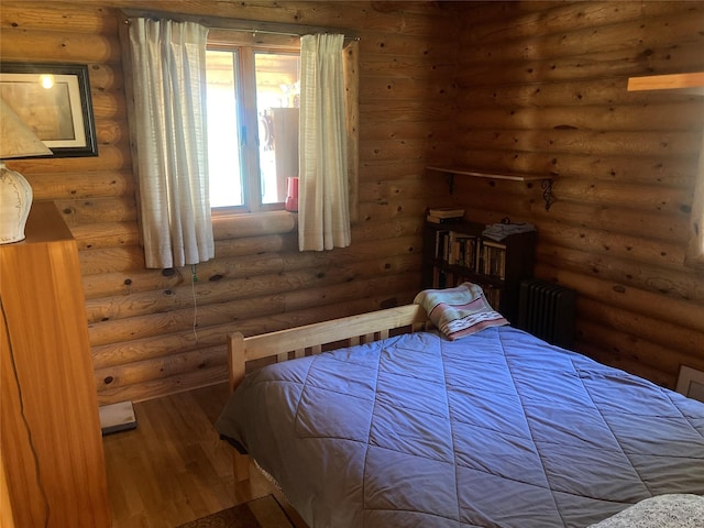 32 Doe Rim Loop, Los Ojos, NM 87551 - bedroom featuring hardwood / wood-style floors, radiator heating unit, and log walls