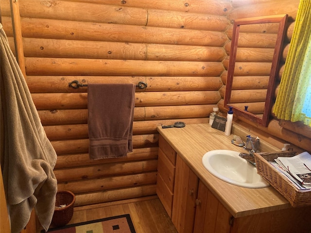 32 Doe Rim Loop, Los Ojos, NM 87551 - bathroom featuring wood-type flooring, vanity, and log walls