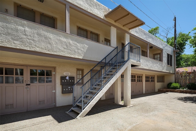 111 E Santa Fe Unit 5, Santa Fe, NM 87505 - doorway to property featuring stucco siding and an attached garage