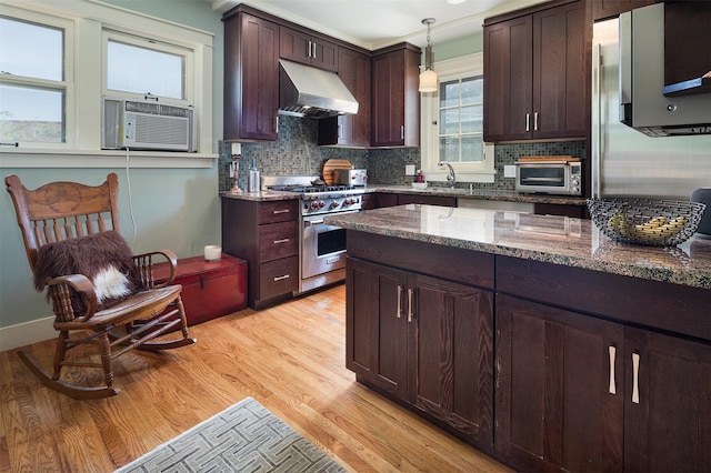111 E Santa Fe Unit 5, Santa Fe, NM 87505 - kitchen featuring under cabinet range hood, luxury range, light wood-type flooring, pendant lighting, and stone countertops