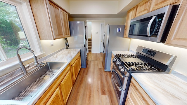 2374 36th Unit B, Los Alamos, NM 87544 - kitchen featuring stainless steel appliances, light wood-style floors, and light brown cabinetry
