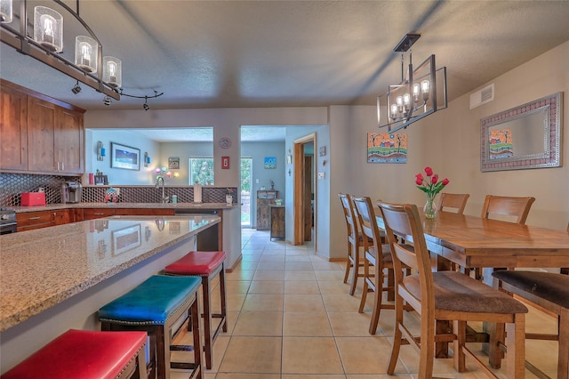 7513 Kachina Loop, Santa Fe, NM 87507 - dining space with a chandelier and light tile patterned floors