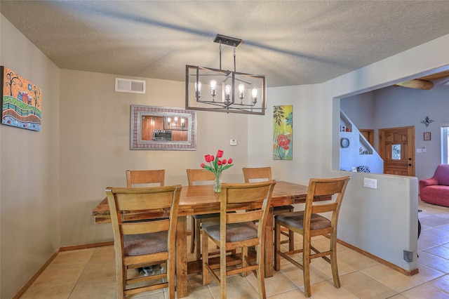 7513 Kachina Loop, Santa Fe, NM 87507 - dining area with light tile patterned floors, a chandelier, and a textured ceiling