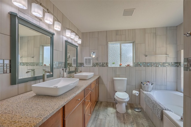 7513 Kachina Loop, Santa Fe, NM 87507 - bathroom featuring tile walls, a tub, double vanity, wood finished floors, and a shower