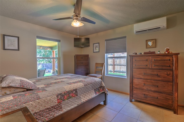 7513 Kachina Loop, Santa Fe, NM 87507 - bedroom featuring an AC wall unit, multiple windows, light tile patterned floors, and ceiling fan
