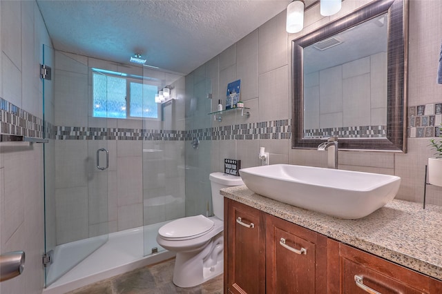 7513 Kachina Loop, Santa Fe, NM 87507 - bathroom with vanity, a stall shower, tile walls, and a textured ceiling