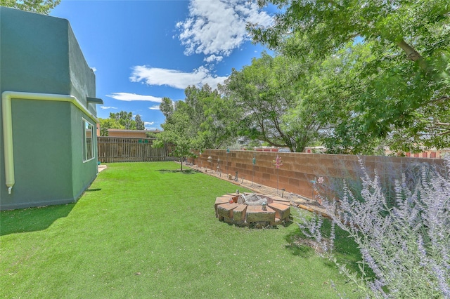 7513 Kachina Loop, Santa Fe, NM 87507 - fenced backyard featuring an outdoor fire pit