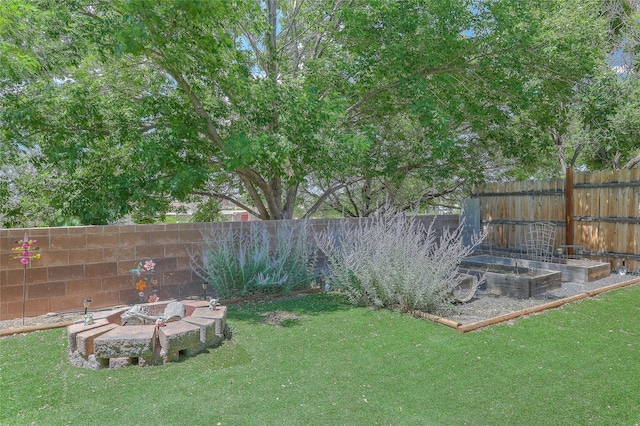 7513 Kachina Loop, Santa Fe, NM 87507 - fenced backyard featuring an outdoor fire pit