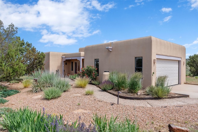 8 Antigua Ct, Santa Fe, NM 87508 - southwest-style home with an attached garage, driveway, and stucco siding