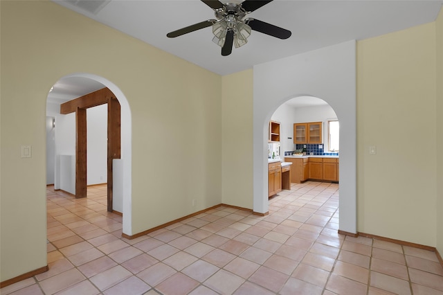 8 Antigua Ct, Santa Fe, NM 87508 - empty room featuring arched walkways, light tile patterned floors, and a ceiling fan