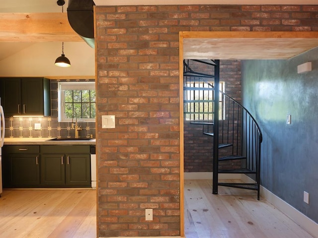1918 Hopewell Unit C, Santa Fe, NM 87505 - kitchen with light wood finished floors, hanging light fixtures, light countertops, backsplash, and vaulted ceiling