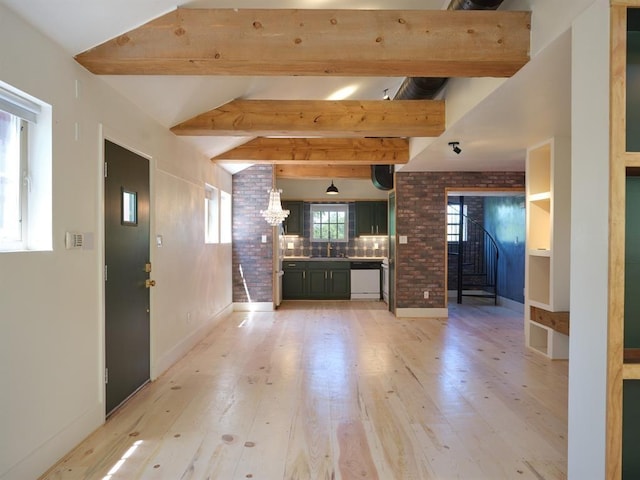 1918 Hopewell Unit C, Santa Fe, NM 87505 - unfurnished living room with light wood-type flooring, beamed ceiling, a chandelier, and stairs