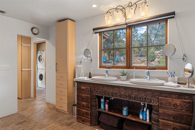 10 Sabina Ln, Santa Fe, NM 87508 - full bath featuring stacked washer and clothes dryer, double vanity, brick patterned floors, and recessed lighting