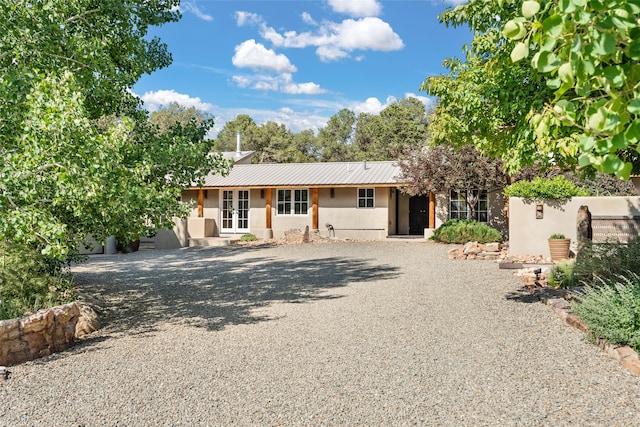 10 Sabina Ln, Santa Fe, NM 87508 - ranch-style house with driveway, a metal roof, and french doors
