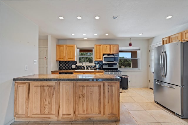 79 Moya Rd, Santa Fe, NM 87508 - kitchen featuring appliances with stainless steel finishes, a peninsula, backsplash, recessed lighting, and light tile patterned floors