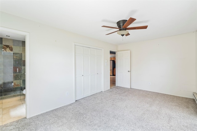 79 Moya Rd, Santa Fe, NM 87508 - unfurnished bedroom with carpet floors, freestanding refrigerator, a closet, connected bathroom, and a ceiling fan