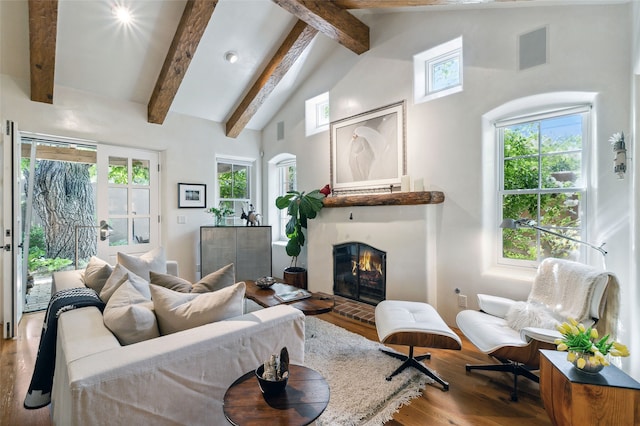 605 Acequia Madre, Santa Fe, NM 87505 - living room with wood finished floors, a fireplace, beamed ceiling, healthy amount of natural light, and high vaulted ceiling
