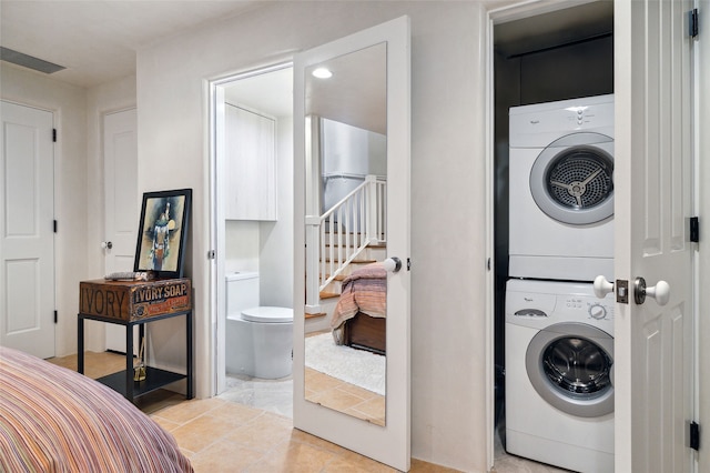 605 Acequia Madre, Santa Fe, NM 87505 - washroom featuring stacked washer / dryer and light tile patterned flooring