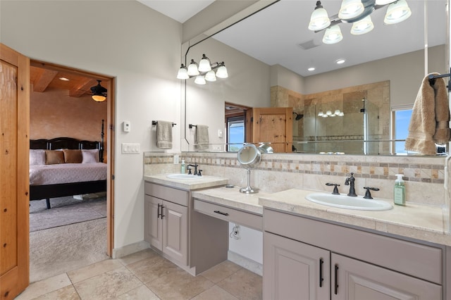 17 Sueno De Santa Fe, Santa Fe, NM 87505 - bathroom featuring double vanity, backsplash, a shower stall, ensuite bath, and tile patterned flooring