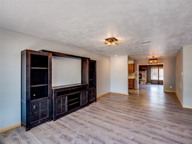 85 Chiquita Dr, White Rock, NM 87547 - unfurnished living room with wood finished floors and a textured ceiling