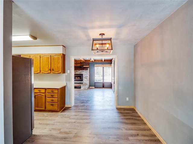85 Chiquita Dr, White Rock, NM 87547 - kitchen with freestanding refrigerator, light wood-style flooring, light countertops, and a chandelier