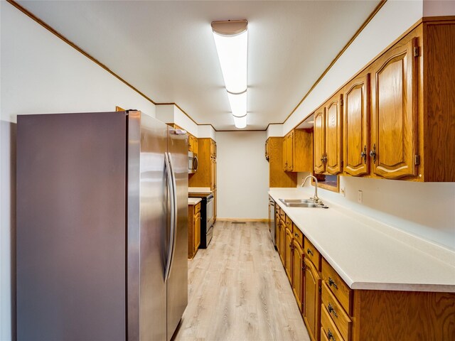 85 Chiquita Dr, White Rock, NM 87547 - kitchen with appliances with stainless steel finishes, brown cabinets, and light wood-style flooring