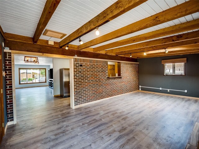 85 Chiquita Dr, White Rock, NM 87547 - unfurnished living room featuring brick wall, wood finished floors, track lighting, beam ceiling, and a chandelier