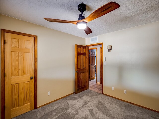 85 Chiquita Dr, White Rock, NM 87547 - unfurnished bedroom with carpet, a textured ceiling, and ceiling fan