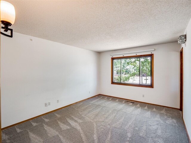 85 Chiquita Dr, White Rock, NM 87547 - carpeted empty room featuring a textured ceiling and baseboards