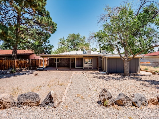 85 Chiquita Dr, White Rock, NM 87547 - rear view of house featuring a patio and board and batten siding