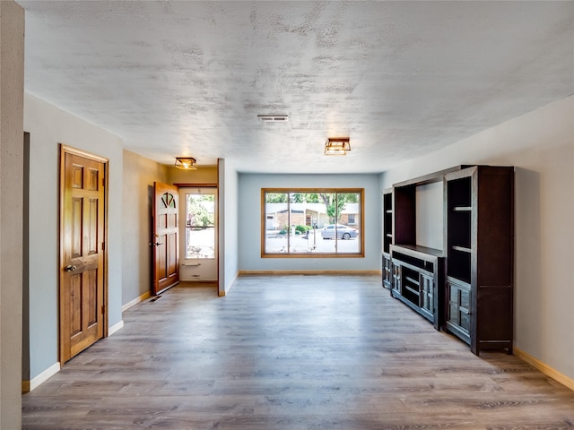 85 Chiquita Dr, White Rock, NM 87547 - unfurnished living room featuring wood finished floors and baseboards