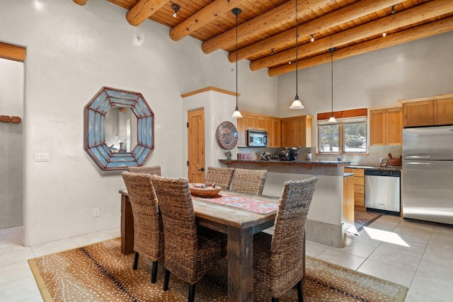 44 Lodge Cir Unit C, Santa Fe, NM 87506 - dining area with a wooden ceiling with exposed beams, a towering ceiling, and light tile patterned floors