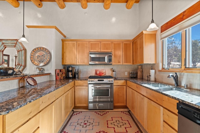 44 Lodge Cir Unit C, Santa Fe, NM 87506 - kitchen with appliances with stainless steel finishes, backsplash, dark stone countertops, and decorative light fixtures
