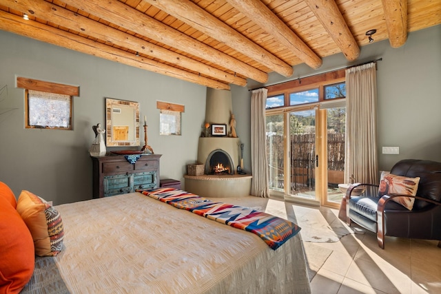44 Lodge Cir Unit C, Santa Fe, NM 87506 - bedroom featuring access to exterior, a wood ceiling with exposed beams, tile patterned floors, and a warm lit fireplace