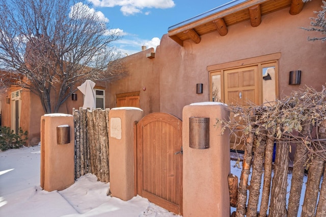44 Lodge Cir Unit C, Santa Fe, NM 87506 - snow covered property featuring a gate